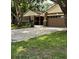 Lovely single-story home with a paved driveway, beautiful trees, and lush green grass at 6342 Butternut Dr, Lakeland, FL 33813