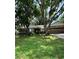 Charming single-story home with a well-maintained lawn and mature trees at 6342 Butternut Dr, Lakeland, FL 33813