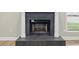 Close up of the fireplace in the living room with tile surround, next to a window at 6342 Butternut Dr, Lakeland, FL 33813
