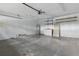 Unfinished garage featuring a utility sink, storage shelves, and water heater at 6342 Butternut Dr, Lakeland, FL 33813