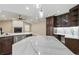 The eat-in kitchen features an eat-in countertop, dark wood cabinetry and stainless-steel appliances at 6342 Butternut Dr, Lakeland, FL 33813