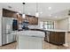 The gorgeous kitchen features marble countertops, stainless steel appliances, and dark wood cabinetry at 6342 Butternut Dr, Lakeland, FL 33813