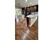 Open kitchen layout with spacious islands, stainless steel appliances, and hardwood flooring at 6342 Butternut Dr, Lakeland, FL 33813