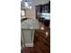 Kitchen island with marble countertop, pendant lights, and hardwood floors at 6342 Butternut Dr, Lakeland, FL 33813