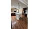 Open-concept kitchen showcasing a large island, modern pendant lighting, and stainless steel appliances at 6342 Butternut Dr, Lakeland, FL 33813