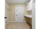 This functional laundry room with tile floors has built-in cabinets and shelving at 6342 Butternut Dr, Lakeland, FL 33813