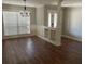 Bright, spacious room featuring wood floors, a chandelier, and built-in shelves at 6342 Butternut Dr, Lakeland, FL 33813