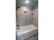 Modern bathroom with walk-in shower featuring custom tile work and built-in shelving at 6342 Butternut Dr, Lakeland, FL 33813