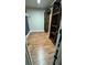Walk-in closet with wooden shelves and laminate flooring at 6342 Butternut Dr, Lakeland, FL 33813