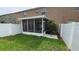 Enclosed backyard featuring a screened-in patio area and privacy fence at 6415 Torrington Cir, Lakeland, FL 33811