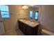 Bathroom with double sinks, vanity, and large mirror at 6415 Torrington Cir, Lakeland, FL 33811