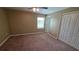 Bedroom with a ceiling fan, carpet floors, and a window at 6415 Torrington Cir, Lakeland, FL 33811