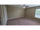 A bright bedroom features a window, closet, and a ceiling fan at 6415 Torrington Cir, Lakeland, FL 33811