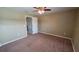 Bedroom featuring carpeted floors and view into the en-suite bathroom and closet at 6415 Torrington Cir, Lakeland, FL 33811