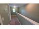 Neutral painted hallway with carpet flooring, a window and white trim at 6415 Torrington Cir, Lakeland, FL 33811