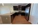 Kitchen with stainless steel appliances, dark wood cabinets, and granite countertops at 6415 Torrington Cir, Lakeland, FL 33811