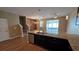 Open-concept kitchen and living area with stainless appliances, breakfast bar, and hardwood style flooring at 6415 Torrington Cir, Lakeland, FL 33811