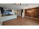 Open-concept kitchen and living area with stainless appliances, breakfast bar, and hardwood style flooring at 6415 Torrington Cir, Lakeland, FL 33811