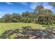 Expansive backyard with lush green grass and mature trees offering plenty of shade at 6819 Broken Arrow S Trl, Lakeland, FL 33813