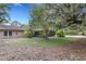 The property features a screened-in porch, mature trees, and a partially visible pool at 6819 Broken Arrow S Trl, Lakeland, FL 33813