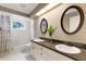 Bathroom with double sinks, a large mirror, vanity, and bathtub with shower at 6819 Broken Arrow S Trl, Lakeland, FL 33813