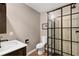 Modern bathroom with a glass-enclosed shower, white sink, and toilet at 6819 Broken Arrow S Trl, Lakeland, FL 33813