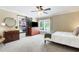 Bedroom with ceiling fan, large window, and barn door closet at 6819 Broken Arrow S Trl, Lakeland, FL 33813