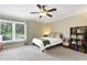 Bedroom with a ceiling fan, large windows, and neutral decor at 6819 Broken Arrow S Trl, Lakeland, FL 33813