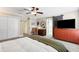 Bedroom showcasing a ceiling fan, en-suite access, and barn door closet at 6819 Broken Arrow S Trl, Lakeland, FL 33813