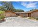 Charming single-story brick home with a two-car garage and lovely landscaped front yard at 6819 Broken Arrow S Trl, Lakeland, FL 33813