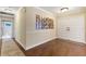 Welcoming foyer featuring hardwood floors and decorative wall art at 6819 Broken Arrow S Trl, Lakeland, FL 33813