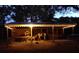 Covered horse barn featuring warm lighting and ample space for multiple horses at 6819 Broken Arrow S Trl, Lakeland, FL 33813