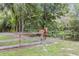 Scenic view showcasing a horse standing near a wooden fence in a lush, green pasture at 6819 Broken Arrow S Trl, Lakeland, FL 33813