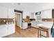 Bright kitchen featuring white cabinets, stainless appliances, dark accent wall, and breakfast bar at 6819 Broken Arrow S Trl, Lakeland, FL 33813