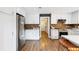 Updated kitchen with white cabinets, stainless steel appliances, and wood-look floors at 6819 Broken Arrow S Trl, Lakeland, FL 33813