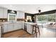 Renovated kitchen with bar seating, stainless steel appliances, and sliding glass doors to the pool at 6819 Broken Arrow S Trl, Lakeland, FL 33813