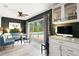 Bright living room with built-in desk, casual dining, and sliding glass doors to the pool at 6819 Broken Arrow S Trl, Lakeland, FL 33813