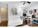 Bright office space featuring a desk, chair, white sofa, hardwood floors, and colorful artwork at 6819 Broken Arrow S Trl, Lakeland, FL 33813