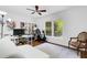 Bright office space with a ceiling fan, large window, desk, bookcase, and exercise bike at 6819 Broken Arrow S Trl, Lakeland, FL 33813