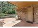 Cozy covered patio with a comfortable chair and a small table, perfect for outdoor relaxation at 6819 Broken Arrow S Trl, Lakeland, FL 33813