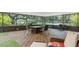 Screened patio featuring comfortable furniture, tile flooring, and providing a relaxing outdoor living space at 6819 Broken Arrow S Trl, Lakeland, FL 33813