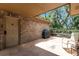 Covered outdoor patio featuring a barbecue grill and comfortable seating area at 6819 Broken Arrow S Trl, Lakeland, FL 33813