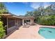 Backyard showcasing a refreshing pool, patio area with lounge chairs, and the back exterior of the home at 6819 Broken Arrow S Trl, Lakeland, FL 33813