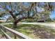 View of the serene property showcasing mature trees, fencing, and well-maintained grounds at 6819 Broken Arrow S Trl, Lakeland, FL 33813