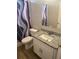 Compact bathroom featuring a granite countertop, toilet, and shower with curtain at 8159 Woodvine Cir, Lakeland, FL 33810