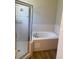 Beautiful bathroom featuring a shower, large soaking tub, and neutral tile work at 8159 Woodvine Cir, Lakeland, FL 33810