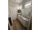 Bright bathroom showcasing a double sink vanity, granite countertops and modern lighting at 8159 Woodvine Cir, Lakeland, FL 33810