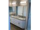 Bright bathroom showcasing a double sink vanity, granite countertops and modern lighting at 8159 Woodvine Cir, Lakeland, FL 33810