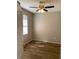 Bedroom with wood-look flooring, window and ceiling fan with overhead lighting at 8159 Woodvine Cir, Lakeland, FL 33810