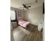 This is a cute bedroom with a plush rug, a window, and a TV at 8159 Woodvine Cir, Lakeland, FL 33810